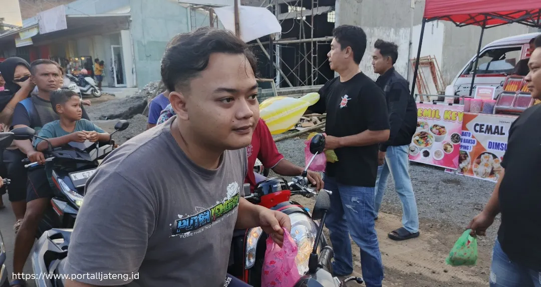 Foto: Ketua Yakuza Farm Pati, Nyaksu membagikan takjil kepada warga sekitar Desa Gembong, Kabupaten Pati.(Portalljateng/Adm)